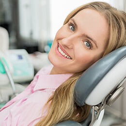 woman in pink laying in dental chair