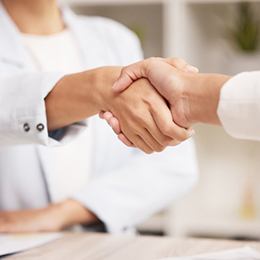 Dentist shaking a patient’s hand