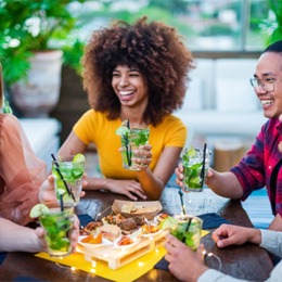 friends smiling and enjoying drinks together