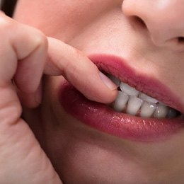 Close-up of a woman biting her fingernails