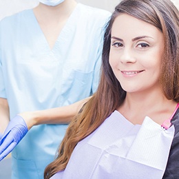 Woman sitting in dental chair and smiling