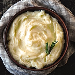 Mashed potatoes in a bowl with a garnish