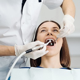 Person receiving a dental checkup and cleaning