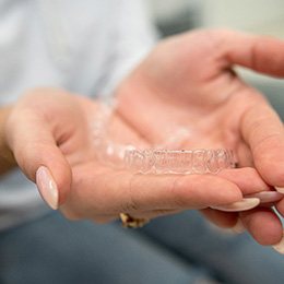 Closeup of patient holding clear aligner