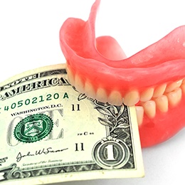 Money clenched in a set of teeth