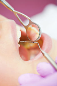 woman receives dental cleaning for healthy gums