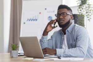 worried person with dental sensitivity on the phone with their emergency dentist