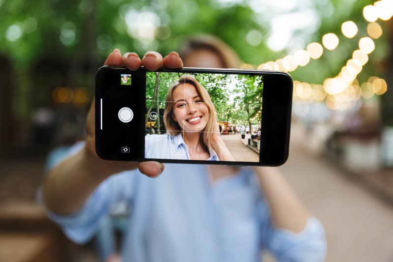 Woman using her phone to take a video of herself